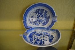 A pair of blue and white leaf shaped dishes.