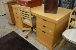 A good modern light oak twin pedestal desk with office swivel chair.