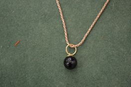 A silver chain and pendant.