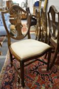 A set of four George III style mahogany shield back dining chairs.