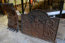 A cast iron fireback and grate.