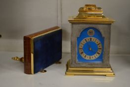 A small mantle clock with bracket.