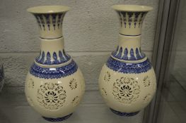 A pair of Chinese blue and white reticulated lantern vases.
