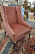 An Edwardian crimson upholstered armchair on cabriole legs.
