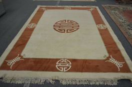 A modern Chinese beige ground carpet with a decorative border 11ft 6ins x 8ft 4ins.