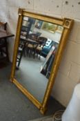 A decorative gilt framed mirror.