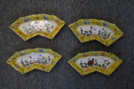A set of four Canton enamel fan shaped dishes.