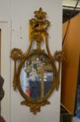 A classical style gilt framed oval mirror.