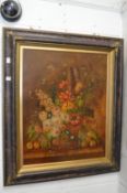 A still life of flowers in a vase on a ledge, oil on canvas in a decorative frame.