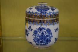 A blue and white jar and cover.