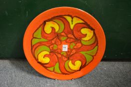 A Poole Pottery Delphis charger, orange ground with stylized floral decoration shape no. 5, 14ins