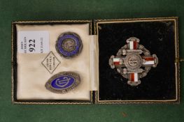 A nurse's silver and enamel brooch in original box, together with two others.