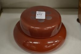 A red tinted glass bowl and cover.