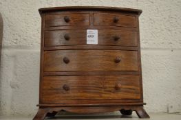 A miniature chest of drawers.