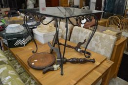 A glass and wrought iron occasional table.