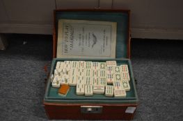 A Mahjong set in a fitted leatherette case.