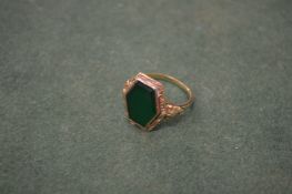 A gold and gem-set ring.