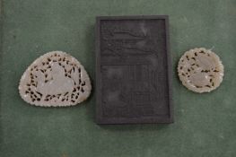 Two Chinese carved jade amulets and another item.
