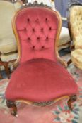 A Victorian rosewood framed button upholstered nursing chair.