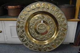 A large embossed brass charger.