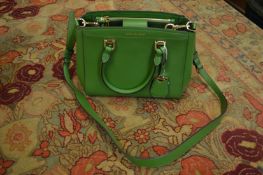 A Michael Kors green leather handbag.