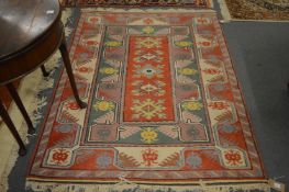 A Persian style rug with geometric decoration.