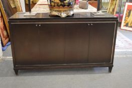 A stylish ebonised four door sideboard with brushed steel inlaid decoration.