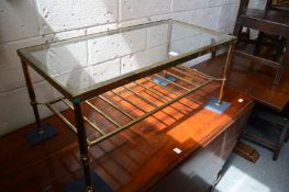 A brass and glass two tier coffee table.