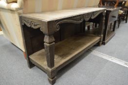 A carved wood two tier stand.