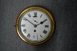 A brass ship's clock engraved 