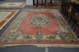 A Chinese pink ground carpet with floral decoration 12ft 6ins x 9ft 2ins.