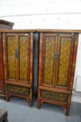 A good pair of highly decorative Chinese gilt decorated lacquer two door cabinets, each with a
