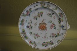 A Famille Rose circular armorial warming dish.