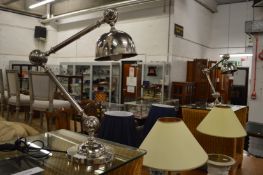 A pair of chrome adjustable table lamps.