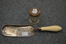 A silver lidded cut-glass jar and a plated crumb scoop.