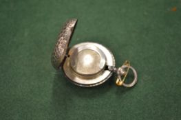 A silver sovereign case.