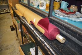 A roll of red velvet material.