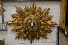 A Metamec sunburst wall clock.