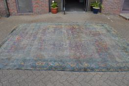 A large early Persian carpet (very badly worn), approx. 13ft x 9ft 10ins.