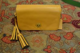 A Coach tan leather small handbag.