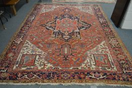 A good Heriz carpet, beige ground with stylized decoration 12ft x 8ft 6ins.