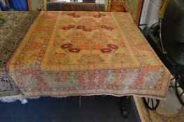 An unusual Persian carpet, beige ground with decoration depicting vases of flowers.