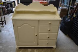 A cream painted bedroom chest.