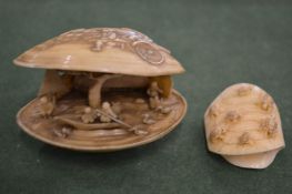 A Japanese ivory clam shaped okimono and a similar item.