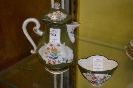 A Dresden small jug and cover and matching tea bowl.