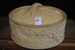 A bisque porcelain game pie dish and cover.
