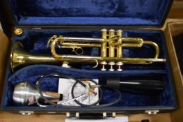 A cased B & M Champion trumpet.