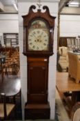 A 19th century oak and mahogany cased longcase clock with painted arched dial.