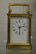 A brass carriage clock.