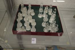 A glass chess set and board.